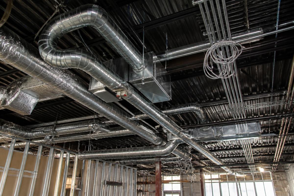 Exposed HVAC ductwork, conduit and piping in a commercial building under construction