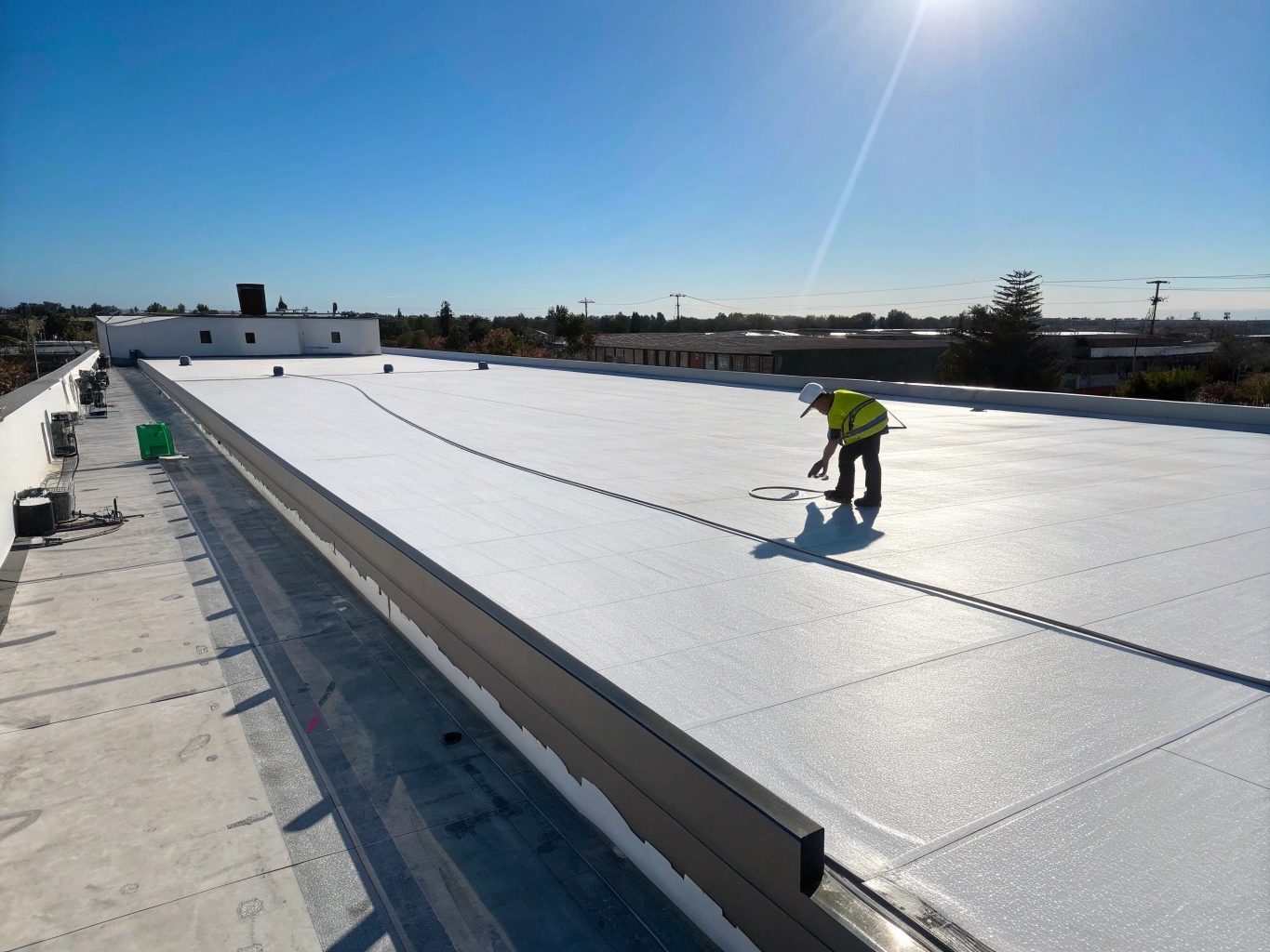 Commercial flat roofing installation showing clean TPO membrane seams
