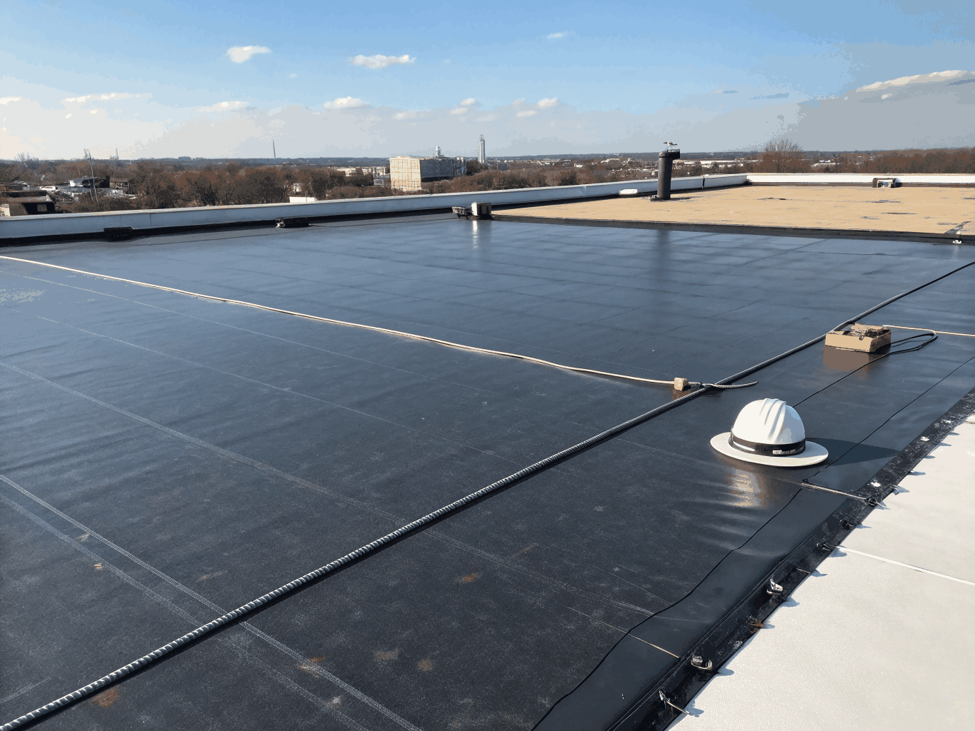 Commercial building roof retrofit showing commercial HVAC flashing and membrane