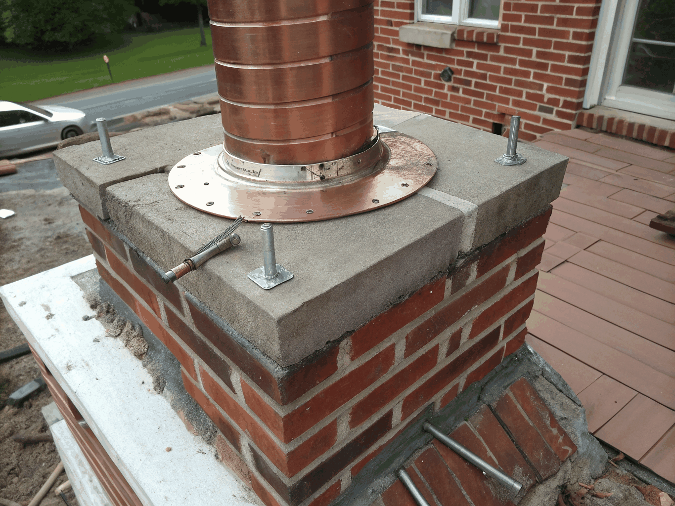 Clean watertight copper and aluminum stepped flashing around chimney