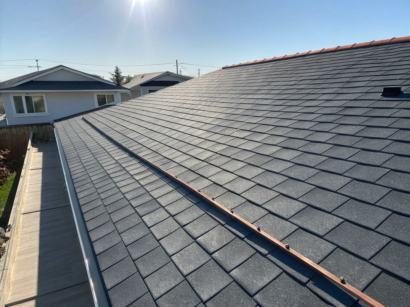 Completed architectural shingle roof with pristine ridge caps