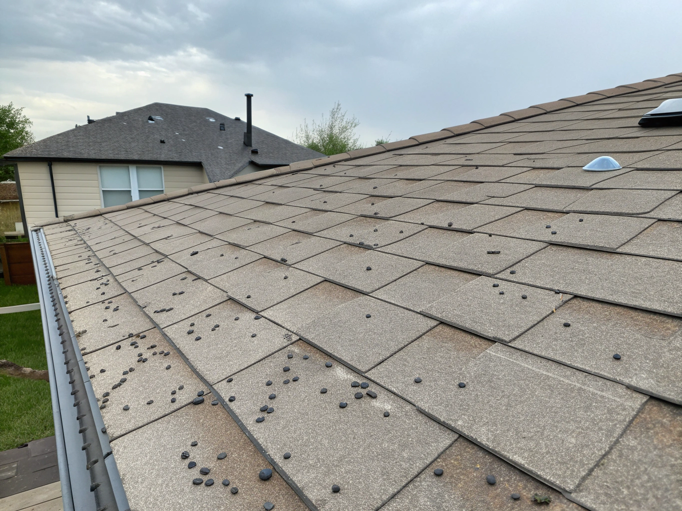 Damaged roof with missing and cracked shingles before repair